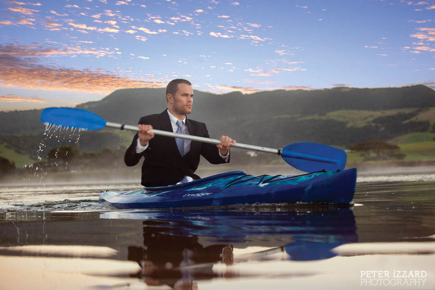 Kiama-man in suit paddling a kayak